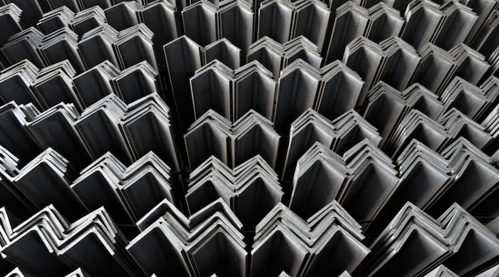 Stacked steel beams representing ferrous metals ready for recycling