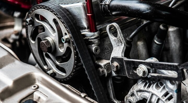 Close-up view of an engine alternator and timing belt assembly