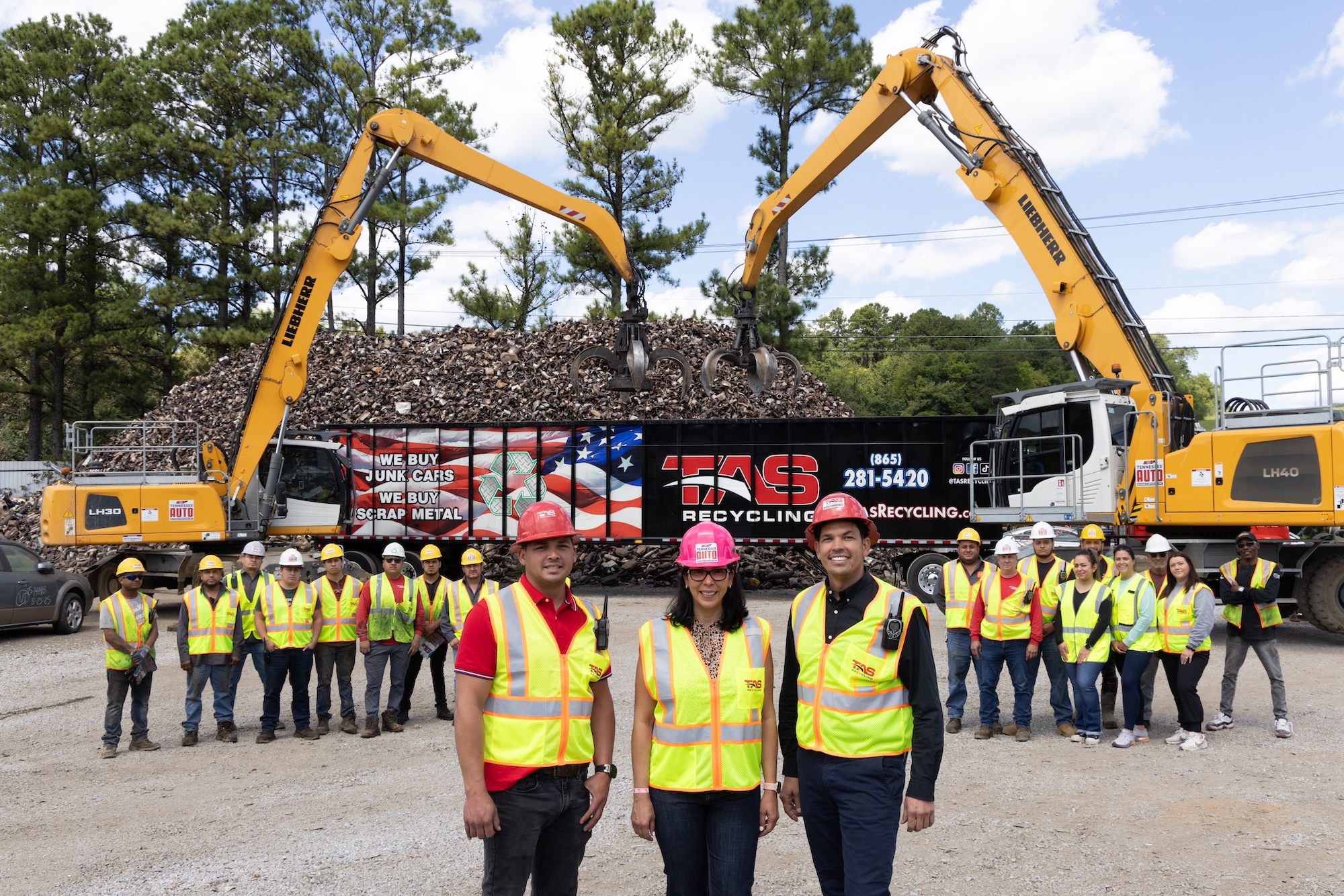 TAS Recycling team standing in front of equipment and truck offering junk car and scrap metal removal services.