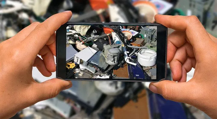 Person taking photo of scrap metal pile with smartphone